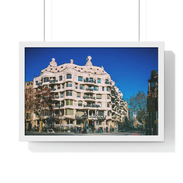 A close-up view of the unique architecture and wrought iron balconies of Casa Pedrera by Gaudi in Barcelona, captured in a framed print with a white frame.