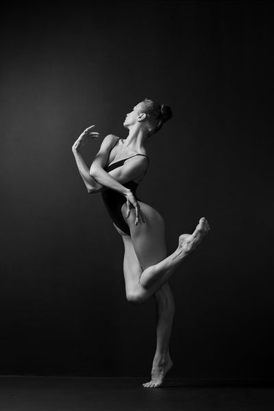 Ballerina, bodysuit, graceful dancing, black and white photography print. Studio photo shooting.