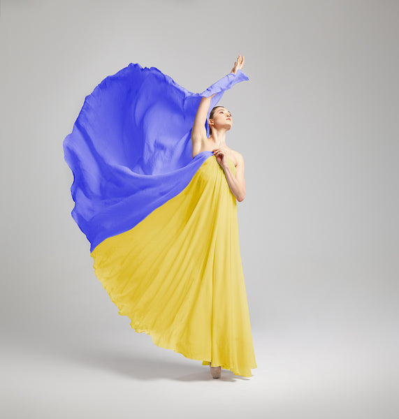 Ballerina moving gracefully covered by a dress in blue and yellow like the Ukrainian flag order this print and all the money will go to the refugees in Ukraine