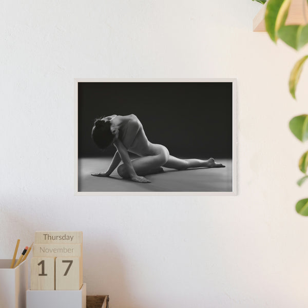 Nude woman doing yoga pose in black and white in white frame on a white wall in a office