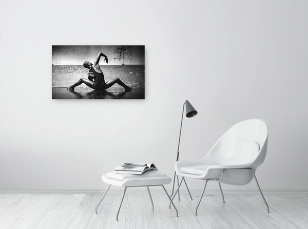 A male dancer captured in mid-air, frozen in time with effortless grace in a black and white fine art print from iDance Contemporary Gallery.